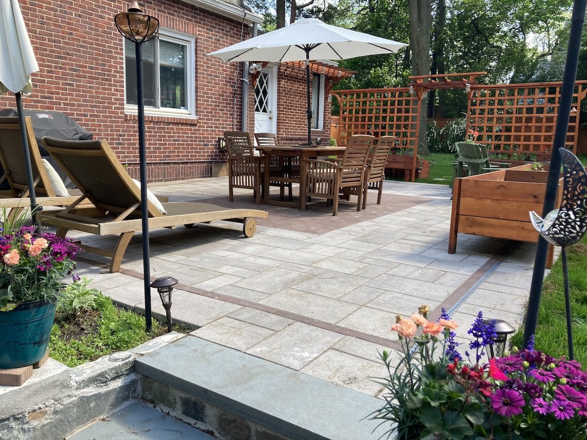 Outdoor patio with pergola, reclining chairs, deck furniture and a raised garden bed.jpg
