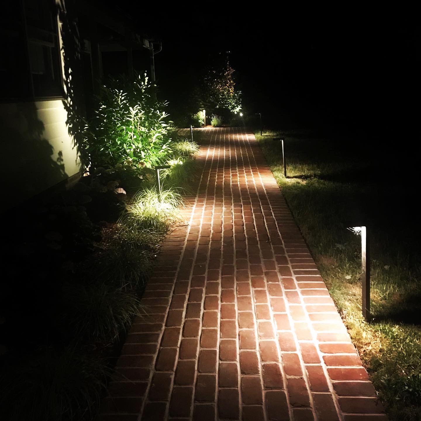 Modern walkway path light along brick entryway to new jersey home.jpg