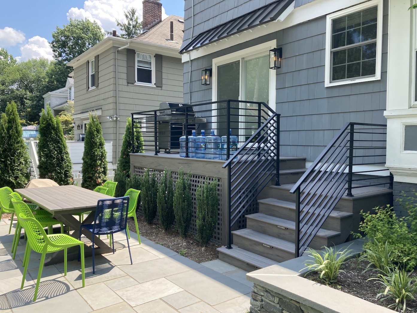 Deck with railing leading to outdoor patio from 2 story home.jpg
