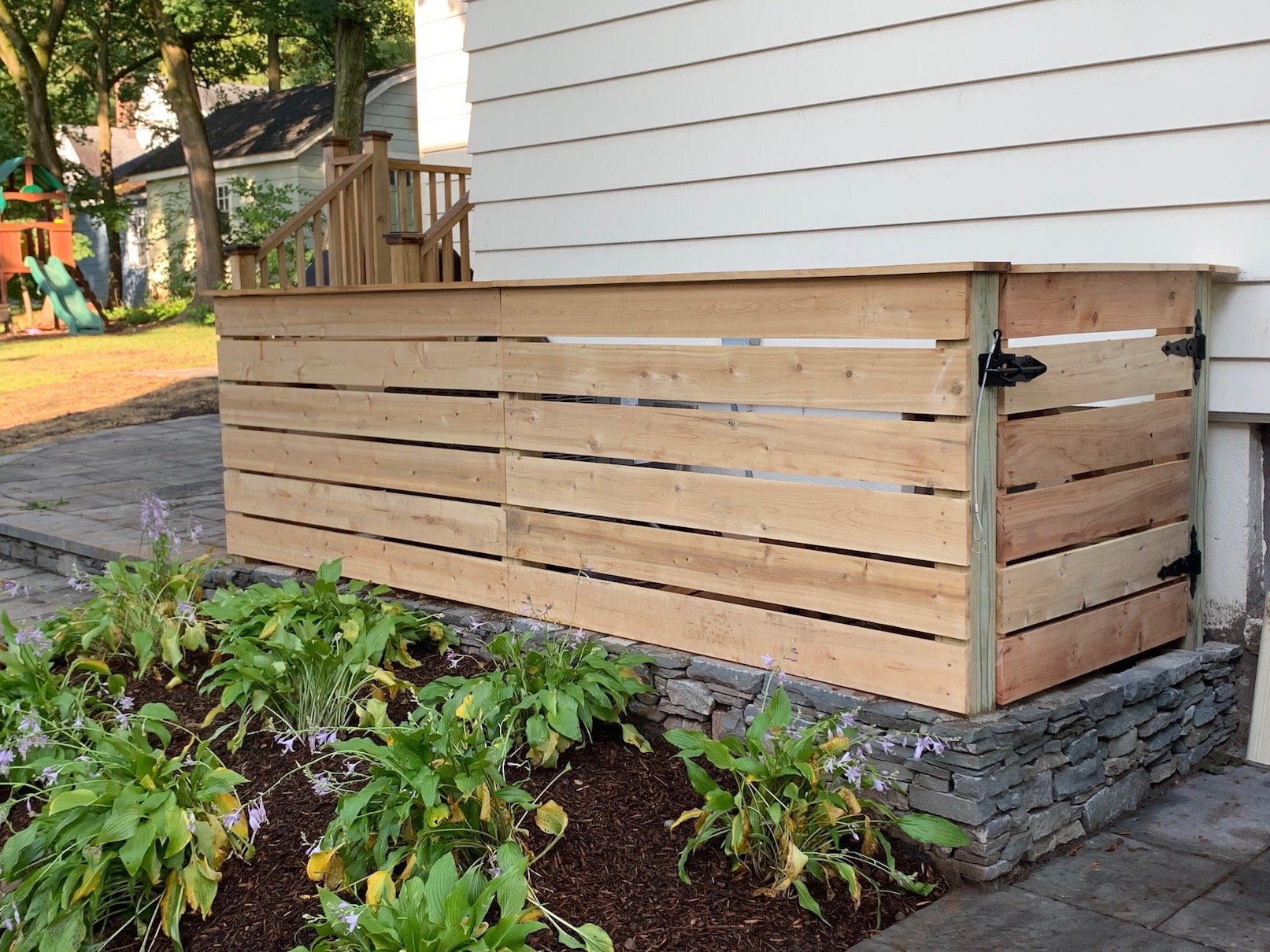 Horizontal cedar wood gate to hide machinery outside home.jpg